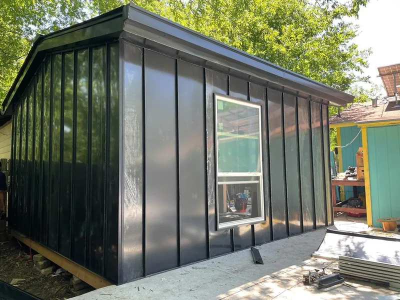 Black standing seam metal wall panels for Roof Inspection in Cadillac