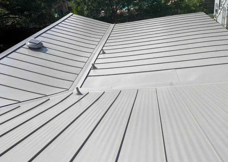 Solar attic fan installed on a metal roof for Roof Ventilation in Cadillac